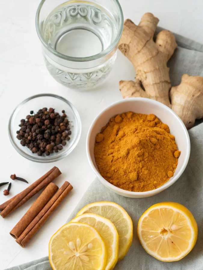 Turmeric hack ingredients including turmeric powder, cinnamon, black pepper, ginger, lemon