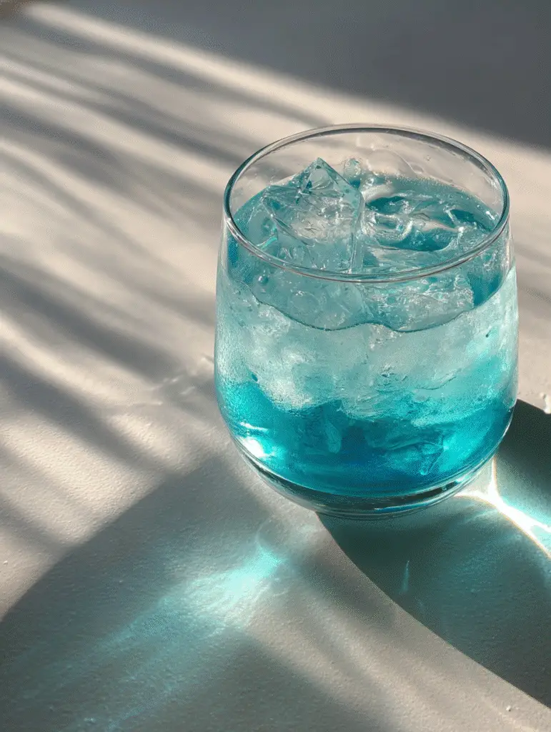 Blue Salt Trick: What It Is, And How It Works Close-up of a chilled glass with the blue salt trick experiment.