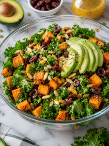 California roasted sweet potato kale salad with avocado, cranberries, almonds, and citrus dressing